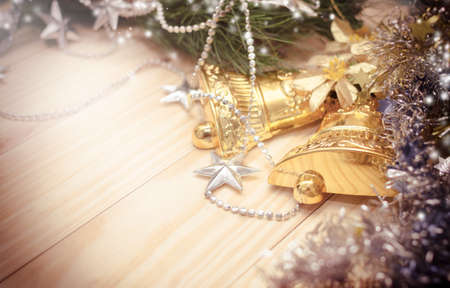 golden bells christmas decoration  with snow and vintage retro filter backgroundの写真素材