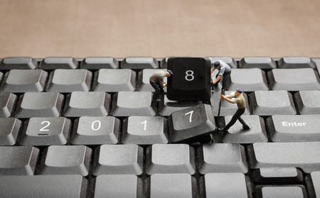 miniature people worker teamwork changing computer keyboard button from 2017 to 2018 new year conceptsの写真素材
