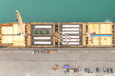 Top view Unloading operation of project  cargo with port heavy lift cranes A crane on a large cargo ship docks loading a new diesel-electric locomotive.  at Laem Chabang Portの写真素材