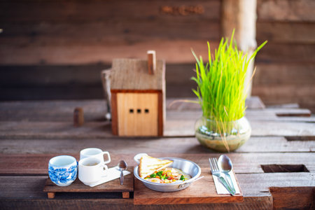 Delicious breakfast with sunny side up eggs,  pancakes, coffee and tea, wood backgroundの写真素材