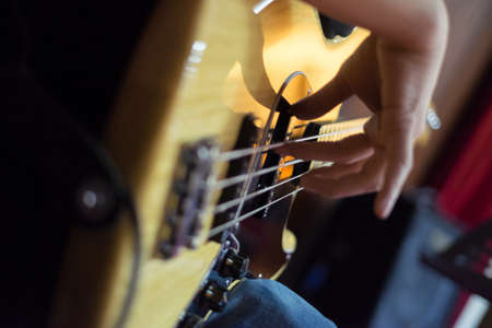 Musician playing on bass guitars.