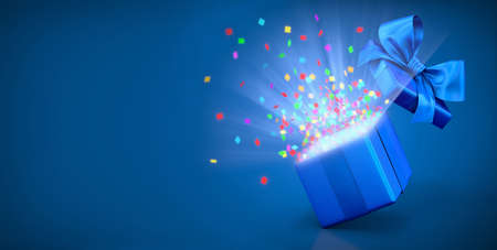 Open gift box with bright rays of lightの写真素材