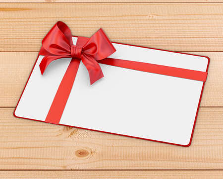 white card and red ribbon bow for Christmas, New Year's Day on wood background 3d renderingの写真素材
