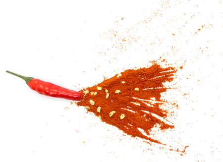 Chili red pepper flakes and chili powder burst isolate white backgroundの写真素材