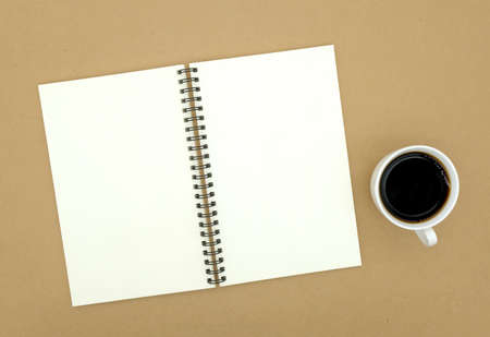 notebook on brown background top view copy space