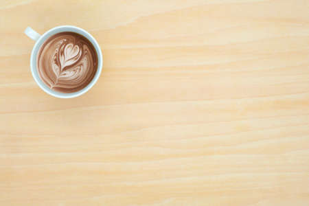 Coffee cup top view on wooden desk backgroundの写真素材