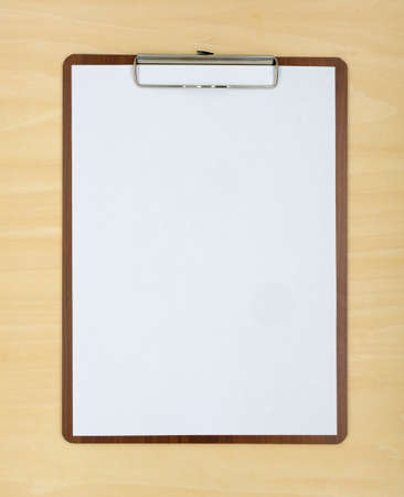 A wooden clipboard with a blank piece of paperの写真素材