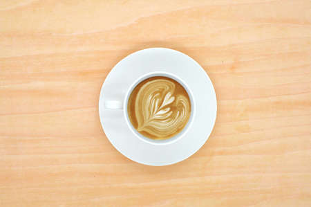 Coffee cup top view on wooden desk backgroundの写真素材