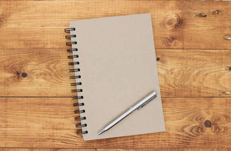 notebook on brown background top view copy spaceの写真素材
