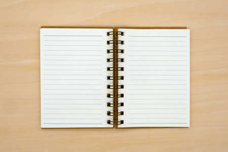 notebook on brown background top view copy spaceの写真素材