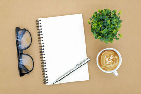 notebook on brown background top view copy spaceの写真素材
