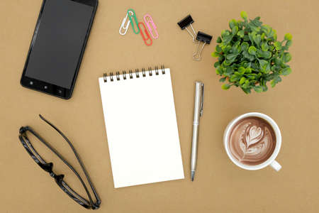 notebook on brown background top view copy spaceの写真素材