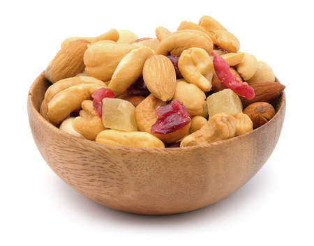 Mixed nuts in a bowl on white wood background.の写真素材