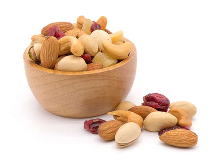 Mixed nuts in a bowl on white wood background.の写真素材