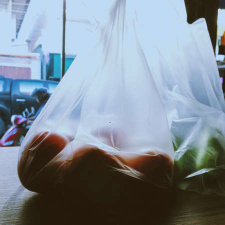 orange in plastic bagの写真素材