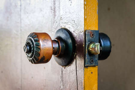 A knob at the old wooden door. Protect Anti-theft Protection.の写真素材