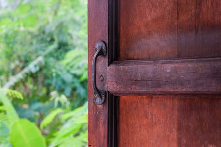 A hand grip at the old wooden door. Protect Anti-theft Protection.の写真素材