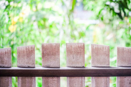 The wooden fence on the foreground and the background is nature.の写真素材