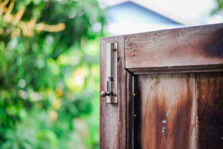 A latch of bar lock at the old wooden window. Protect Anti-theft Protection.の写真素材