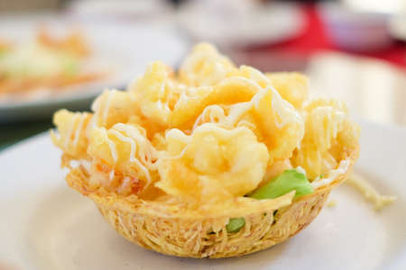 Fried shrimp salad cream serve on flour basket for food background.の写真素材