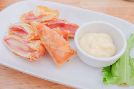 " Deep fried spring roll with ham cheese " serve on dish with salad sauce , Thailand.の写真素材