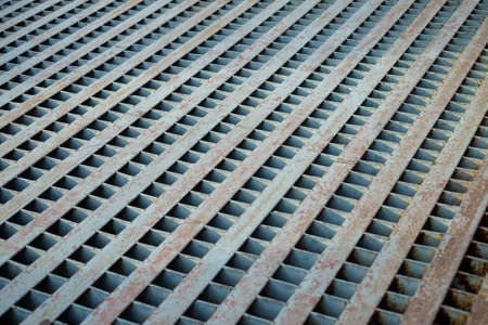 Vintage grille sewage pipe with rust for cover the drain on concrete road or street.の写真素材