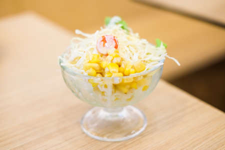 Vegetable (tomato, cabbage & corn) salad serve in clear bowl for homemade food background or texture - Healthy & diet concept.の写真素材