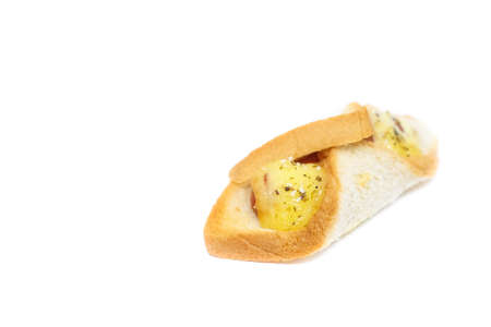 Sausage wrapped in egg bread (sandwich) with mayonnaise sauce and sprinkle little dried oregano isolated on white background - homemade food concept.の写真素材