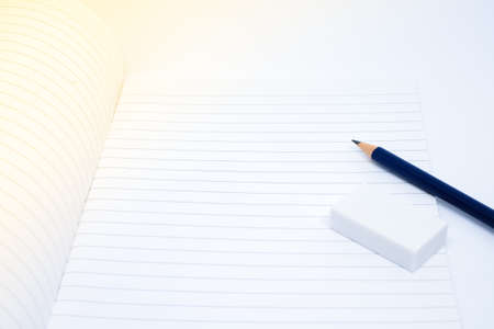 Pencil, eraser (rubber) and blank white notebook for write your note - texture & education concept.の写真素材