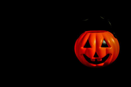 Hanging many horror or scary pumpkin for Halloween Day concept, space for your content and isolated on black background.の写真素材