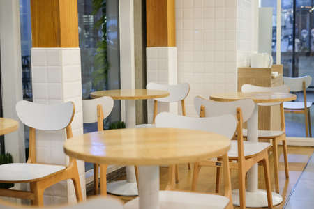 White chair and brown wooden table set for breakfast, lunch and dinner - interior concept.の写真素材