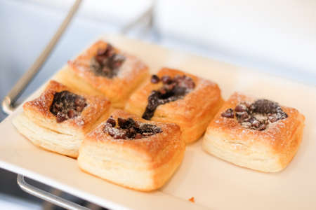 Homemade chocolate chips danish serve on white plate - dessert background or texture.