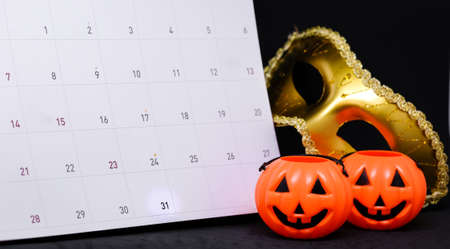 31 October on calendar with fantasy mystery golden mask & scary pumpkin - Halloween Day concept.の写真素材