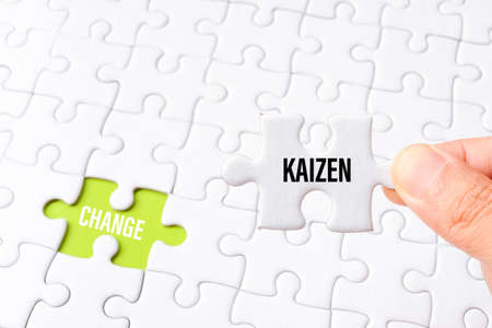 The kaizen word on white jigsaw go to replace change word on green gap - idea answer concept.の写真素材
