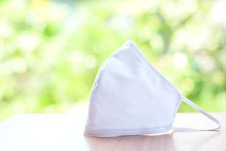 Cloth white mask isolated on nature background - for prevent dust (PM 2.5), disease (Coronavirus or COVID-19).の写真素材