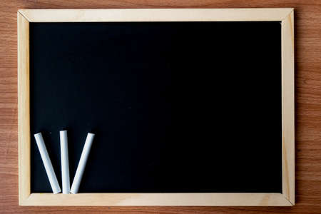 The blackboard in wooden frame with dirty chalkboard and space for your content - texture, background and dark tone concept.の写真素材