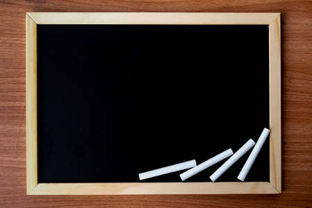 The blackboard in wooden frame with dirty chalkboard and space for your content - texture, background and dark tone concept.の写真素材
