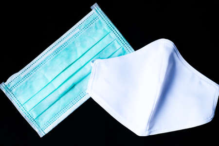 Cloth white mask and surgical mask isolated on black background - for prevent dust (PM 2.5), disease...