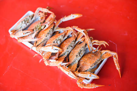 The steamed crab (claws) serve on white dish - homemade food concept.
