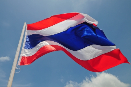 Image of waving Thai flag of Thailand with blue sky background.の写真素材