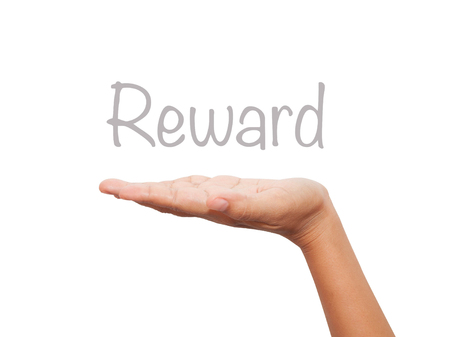 Hand present Rewards on blank transparent board with a marker isolated over black background. Business concept. Stock Photoの写真素材