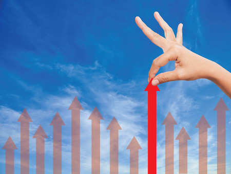 hand  Pulling arrows on sky backgroundの写真素材