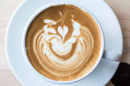 Coffee with latte art on the surface.