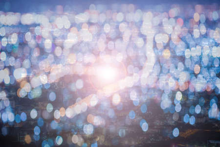 Blurred city and bokeh abstract background with light flare.の写真素材
