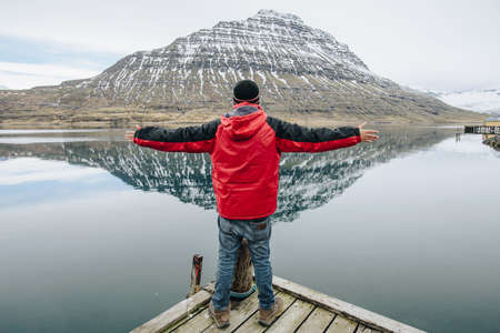 Portrait of man travel and standing in front of HÃ³lmatindur an iconic mountain in...
