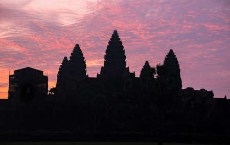 The silhouette of Angkor Wat before sunrise in Siem Reap province of Cambodia. Angkor Wat is an...