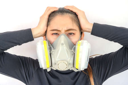 Portrait of young Asian woman wearing gas mask for protect smog bad air pollution or toxic. Air pollution has been associated with diseases of the heart and lungs, cancers and other health problems.の写真素材