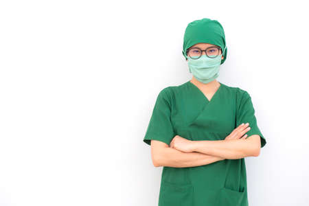 Portrait of young confident woman wearing surgical mask with isolated white wall background. Healthcare worker and Medical concept.の写真素材