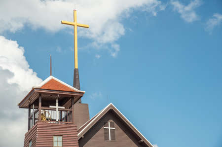 The bell tower and Latin cross of Wiang Chiang Rai Christian Church 1, the first church in Chiang Rai City (completed 1914) built by Dr.William A.Briggs the American Presbyterian Missionary Team.の写真素材