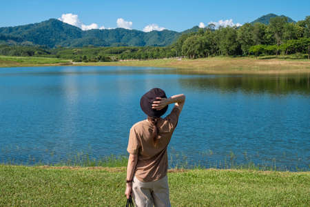 Back view of young tourist woman enjoying her holiday with beautiful tranquility view of the nature in Chiang Rai the northernmost province of Thailand.の写真素材